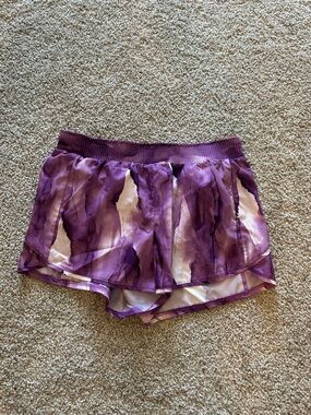 Purple running shorts with built-in lining.